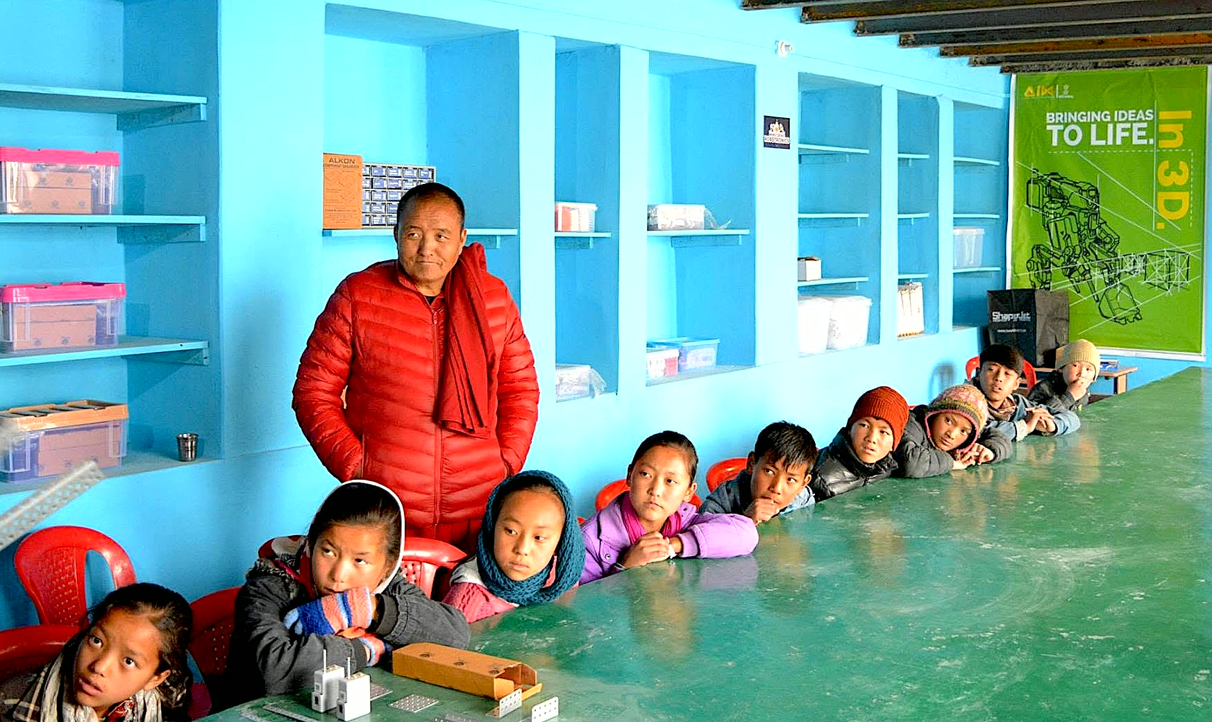 Students and instructors working around electronics equipment in a NinjaMinds classroom