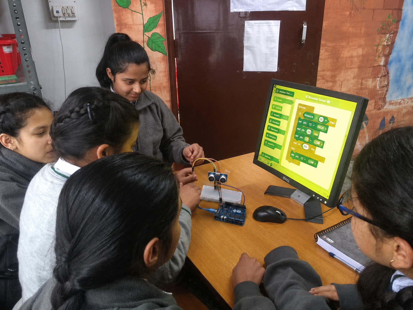 Students programming an Arduino sensor circuit
